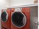 Efficient laundry area with stacked washer and dryer, maximizing space in this home at 8421 E 29Th Ave, Denver, CO 80238