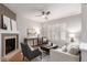 Bright living room with a fireplace, ceiling fan, and comfortable seating at 8421 E 29Th Ave, Denver, CO 80238