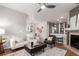 Open-concept living room with hardwood floors, fireplace, and neutral tones at 8421 E 29Th Ave, Denver, CO 80238