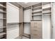 Bright walk-in closet boasts shelving, hanging rods, and drawers for optimal storage solutions at 8421 E 29Th Ave, Denver, CO 80238