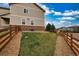 Backyard featuring a stone and wood fence, grass, and well maintained landscaping at 4808 S Picadilly Ct, Aurora, CO 80015