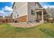 View of backyard with stone accents, wooden fence, and small porch at 4808 S Picadilly Ct, Aurora, CO 80015