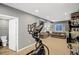 Finished basement boasting a workout area and rec room with comfortable seating and a nearby half bath at 4808 S Picadilly Ct, Aurora, CO 80015