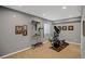 Finished basement featuring workout area with elliptical machine and fitness equipment and neutral carpeting at 4808 S Picadilly Ct, Aurora, CO 80015