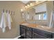 Bathroom with double vanity, granite countertops, and ample storage at 4808 S Picadilly Ct, Aurora, CO 80015