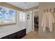 Modern bathroom featuring a bathtub, separate shower, and access to a walk-in closet at 4808 S Picadilly Ct, Aurora, CO 80015