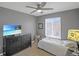 Neutral bedroom featuring a TV and a large window overlooking the neighborhood at 4808 S Picadilly Ct, Aurora, CO 80015