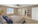 Bright bedroom featuring a ceiling fan, large windows, and neutral color palette, with ensuite bathroom access at 4808 S Picadilly Ct, Aurora, CO 80015
