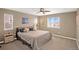 Bright bedroom featuring a ceiling fan, large windows, and neutral color palette, creating a cozy and inviting space at 4808 S Picadilly Ct, Aurora, CO 80015