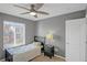 Cozy bedroom featuring a ceiling fan, a large window, and neutral color palette at 4808 S Picadilly Ct, Aurora, CO 80015