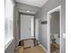 Entryway view featuring a white front door, hardwood floors, and adjacent half bathroom at 4808 S Picadilly Ct, Aurora, CO 80015