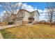 Charming two-story home with attached garage, stone accents, manicured lawn and wood fence at 4808 S Picadilly Ct, Aurora, CO 80015