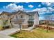 Charming two-story home with attached garage, stone accents, manicured lawn and wood fence at 4808 S Picadilly Ct, Aurora, CO 80015