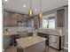 Modern kitchen with granite countertops, stainless appliances, and a center island featuring pendant lighting at 4808 S Picadilly Ct, Aurora, CO 80015