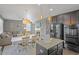Spacious kitchen with granite island, stainless appliances, and open view to the living room and dining area at 4808 S Picadilly Ct, Aurora, CO 80015