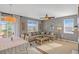 Bright living room featuring a comfortable sectional sofa, ceiling fan, and a neutral color palette at 4808 S Picadilly Ct, Aurora, CO 80015