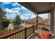 Covered porch with cozy seating area offering neighborhood views and shade trees at 4808 S Picadilly Ct, Aurora, CO 80015