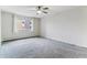Empty Bedroom with ceiling fan, large window and neutral carpet at 9385 E Center Ave # 6A, Denver, CO 80247