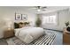 Cozy bedroom with a ceiling fan, large window, and stylish decor at 9385 E Center Ave # 6A, Denver, CO 80247