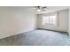 Bare bedroom with a window offering natural light and neutral carpet at 9385 E Center Ave # 6A, Denver, CO 80247