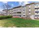 Apartment building with a well-manicured lawn and multiple units at 9385 E Center Ave # 6A, Denver, CO 80247