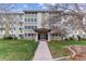 Apartment building exterior with well-maintained lawn and landscaping at 9385 E Center Ave # 6A, Denver, CO 80247