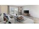Bright living room with sliding glass doors, neutral decor, and modern furniture at 9385 E Center Ave # 6A, Denver, CO 80247