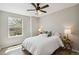 Bright bedroom with wood floors, white bedding, a ceiling fan and good natural light at 1169 Thornbury Pl, Highlands Ranch, CO 80129