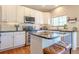 Bright kitchen featuring white cabinets, stainless steel appliances, and black countertops at 1169 Thornbury Pl, Highlands Ranch, CO 80129