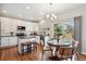 Eat-in kitchen with white cabinets, stainless steel appliances, and a dining area at 1169 Thornbury Pl, Highlands Ranch, CO 80129