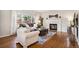 Cozy living room featuring a fireplace, a large window, and comfortable seating at 1169 Thornbury Pl, Highlands Ranch, CO 80129