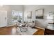 Bright living room with natural light and neutral decor with hardwood floors at 1169 Thornbury Pl, Highlands Ranch, CO 80129