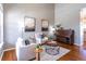 Bright living room with high ceilings, stylish furnishings, and warm hardwood floors at 1169 Thornbury Pl, Highlands Ranch, CO 80129