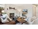 Inviting living room with a fireplace, decorative mantel, and a stylish coffee table at 1169 Thornbury Pl, Highlands Ranch, CO 80129