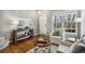 Cozy living room featuring modern decor, hardwood floors and abundant light at 1169 Thornbury Pl, Highlands Ranch, CO 80129