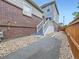 View of backyard with landscaping rocks and walking path leading to the patio deck with stairs at 3921 E 141St Ave, Thornton, CO 80602