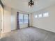 Bright, carpeted bedroom with a ceiling fan, multiple windows, and neutral walls creating a serene space at 3921 E 141St Ave, Thornton, CO 80602