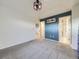 A carpeted bedroom with blue accent wall and a peek into the adjoining bathroom and hallway at 3921 E 141St Ave, Thornton, CO 80602