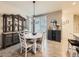 Dining room with chandelier, hardwood floors, and seamless flow into the kitchen area at 3921 E 141St Ave, Thornton, CO 80602