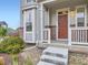 Home with brick and siding exterior showcasing a covered front porch and landscaped front yard at 3921 E 141St Ave, Thornton, CO 80602