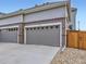 View of the exterior of the home featuring the garage doors at 3921 E 141St Ave, Thornton, CO 80602
