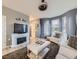 Inviting living room with modern fireplace, plush seating, bay windows, and stylish decor at 3921 E 141St Ave, Thornton, CO 80602