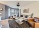 Bright living room with comfortable seating, a bay window, hardwood floors, and stylish decor at 3921 E 141St Ave, Thornton, CO 80602