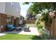 Backyard featuring a patio with comfortable seating, a lush lawn, and mature trees at 3785 E 134Th Ct, Thornton, CO 80241