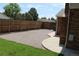 Gravel-covered backyard with a wooden fence and access to the brick house at 3785 E 134Th Ct, Thornton, CO 80241