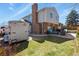 Large backyard featuring a well-kept lawn, patio with furniture, and mature trees at 3785 E 134Th Ct, Thornton, CO 80241