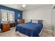Comfortable bedroom with blue accents, a desk, and a large window at 3785 E 134Th Ct, Thornton, CO 80241