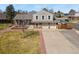 Charming home featuring a spacious driveway, a two-car garage, and well-maintained landscaping at 3785 E 134Th Ct, Thornton, CO 80241