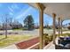 Cozy covered front porch with comfortable seating, views of a lush yard, and a glimpse of neighborhood charm at 3785 E 134Th Ct, Thornton, CO 80241