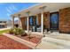 Charming front porch features brick accents, comfortable seating, and a welcoming entrance at 3785 E 134Th Ct, Thornton, CO 80241